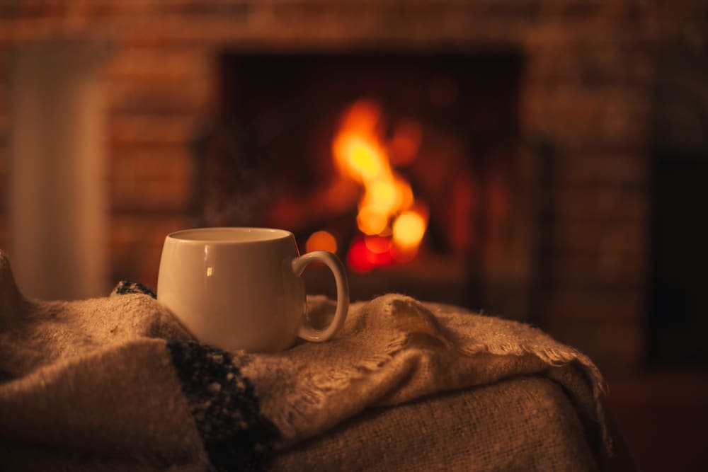 A cozy scene with a warm cup of tea while enjoying romantic cabin getaways